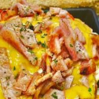 Ham And Cheese Skillet · Home fries, peppers and onions with ham, cheddar cheese and two eggs over easy (or your choi...