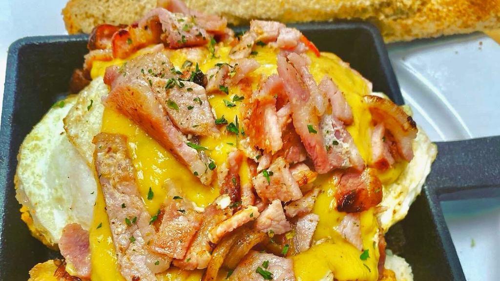 Ham And Cheese Skillet · Home fries, peppers and onions with ham, cheddar cheese and two eggs over easy (or your choice) with Hollandaise sauce. Choice of toast.