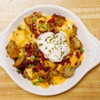 Loaded Home Fries · home fries topped with melted cheese, bacon bits, scallion and dollop of sour cream.