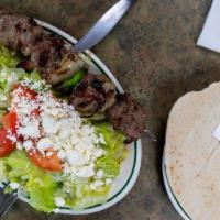 One Skewer Lamb Kebab Open Sw · one skewer lamb kebab on greek salad and serve with pita bread