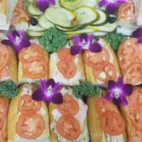Kippered Salmon Platter · Includes lettuce, tomato, onion, cucumber, olives, cream cheese, and a bagel.