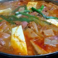 Budae-Jjgae/ Spicy Sausage Stew · Spicy sausage stew. Stew consisting of ham, sausage, pork, kimchi, and tofu in a beef stock....