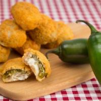 Jalapeño Poppers · Juicy jalapeño poppers breaded and filled with cheese then fried till golden.