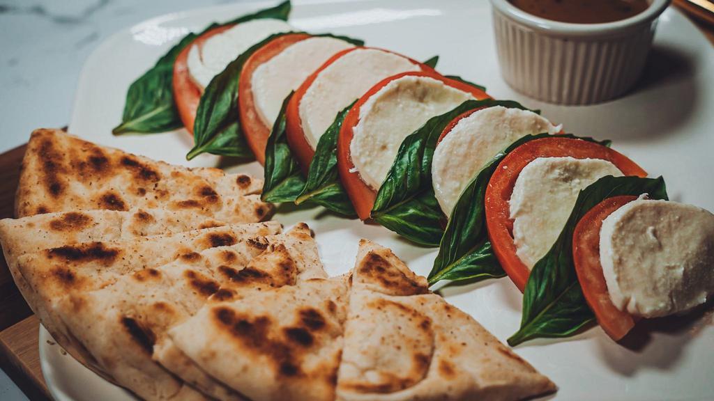 Caprese Salad · Fresh basil, tomato and fresh mozzarella cheese, drizzled with extra virgin olive oil.