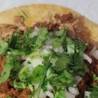 Taco · Corn tortilla, onions, cilantro, green salsa.