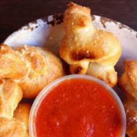 Garlic Knots (6) · Knots of our homemade dough smeared with our garlic butter sauce and sprinkled with Parmesan...