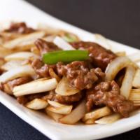 Mongolian Beef · Cuts of pork steak w/ onions, mushrooms & scallions in our caramelized brown sauce.