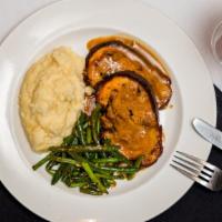 Stuffed Pork Loin · Oven roasted stuffed pork loin served with mashed potato, green beans, and a side of pork gr...
