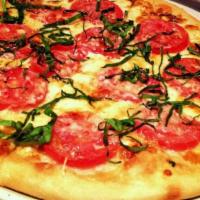 Margherita Pizza · Roma tomatoes, garlic oil, basil, mozzarella, parmesan and aged provolone cheese.  850 cal.