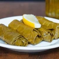 Stuffed Grape Leaves. Vegan · Hand rolled grape leaves stuffed with rice and vegetables.