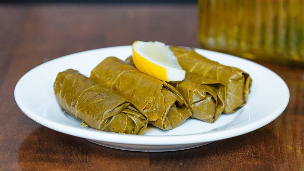 Stuffed Grape Leaves. Vegan · Hand rolled grape leaves stuffed with rice and vegetables.