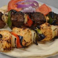 Filet Mignon Kebab Skewer · Four chunks of filet mignon with peppers and onions.