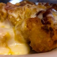 Loaded Tots · Tater Tots topped with Melted Cheese and Bacon