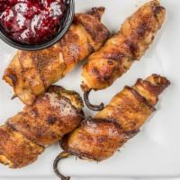 Smoked Jalapeños · Stuffed with cream cheese and wrapped with hickory-smoked bacon served with raspberry dippin...