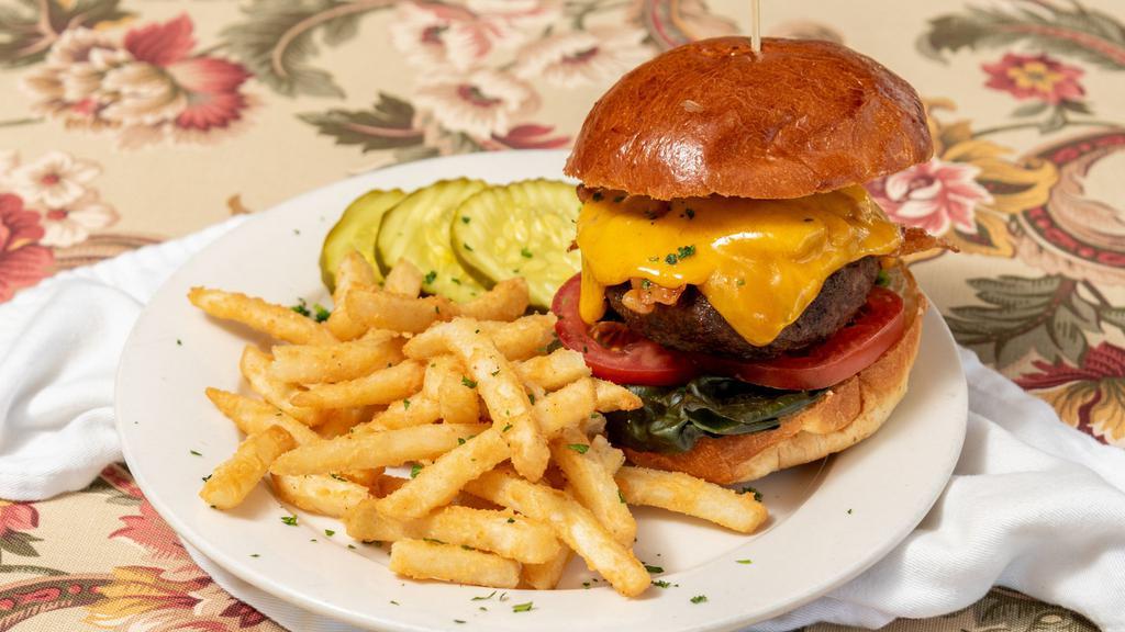 Beef Burger · Lean ground sirloin grilled to your liking, caramelized onions, bacon, lettuce, tomato, choice of cheddar, swiss, monterey jack, or bleu cheese, homemade bun, served with sweet potato or regular fries.