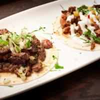 Carne Asada · Grilled steak, white onion, and cilantro relish with roasted red pepper salsa. Served with M...