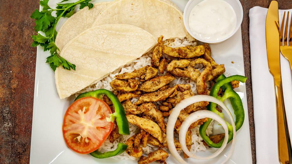 Grilled Fish & Chicken Fajita · Comes With Fish & Chicken Fajita, Lettuce, Tomato, Green Pepper, Red Onions, White Sauce, 2 Tortillas, Basmati Rice, Grilled Chicken, Grilled Fish and Roasted Beans.
