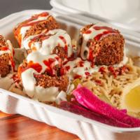 Falafel Over Rice · Served over basmati rice with salad and a choice of our homemade Tahini and hot sauce.