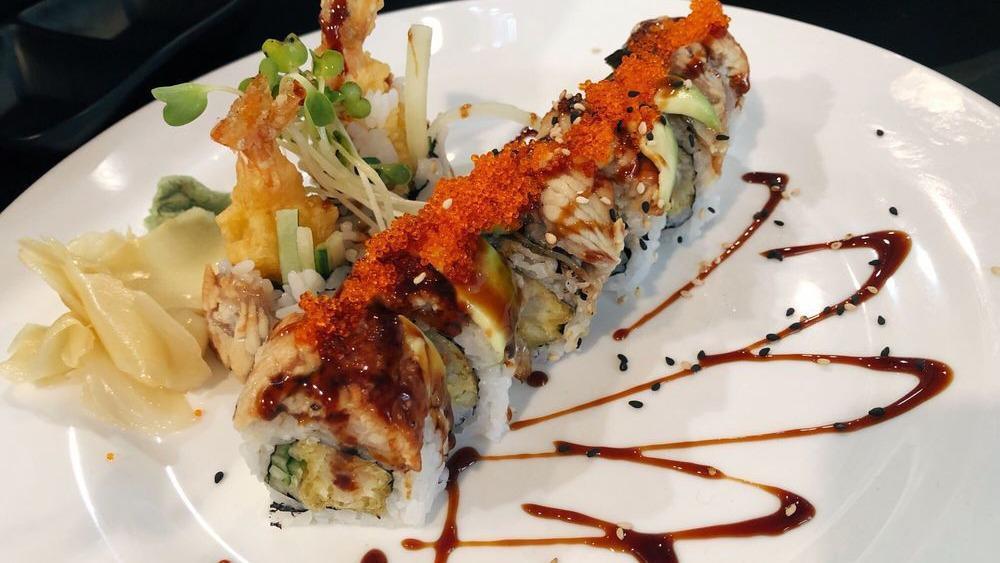 Tiger Eye · Deep fried smoked salmon, crabstick, avocado roll topped with spicy Japanese sauce and eel sauce.