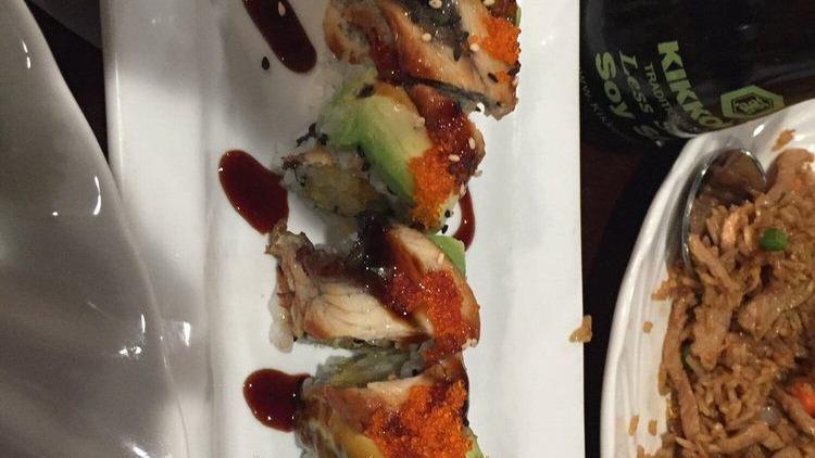 Dragon · Shrimp tempura, cucumber roll topped with eel, avocado, tobiko and eel sauce.