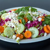 Ali Baba Salad · Fresh tomatoes, lettuce, red cabbage, carrots and cucumbers topped with feta cheese and dres...