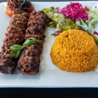 Adana Kebab · Chopped lamb, seasoned with spices, red bell pepper and char grilled. Served with bulqur, sa...