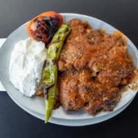 Iskender · Slices of doner (gyro) mixed with tomato sauce, yogurt topped with buttered homemade bread s...
