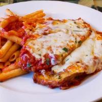 Eggplant Parmigiana · Layered eggplant with mozzarella and romano cheese. Served with penne.