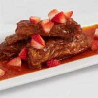 Bbq Baby Ribs · Broiled ribs smothered in BBQ sauce and garnished with strawberries