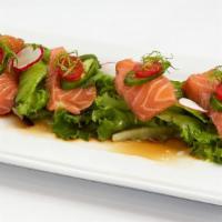 Salmon Carpaccio · Torched fresh seasoned raw salmon topped with jalapenos, tomatoes, and scallions.  Served wi...