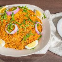 Chicken Biryani · Boneless chicken cooked in aromatic spices, layered with a blanket of basmati rice.
