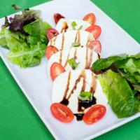 Caprese Salad · Fresh mozzarella, cherry tomato, basil, balsamic dressing.