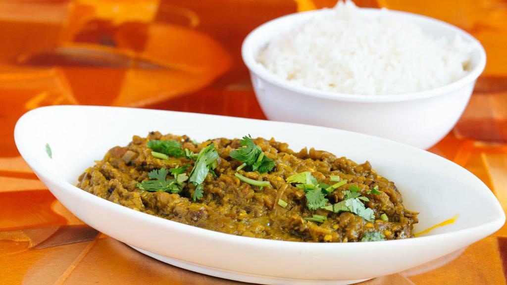 Baigan Bharta · Oven roasted eggplant mashed and finished with onions, tomatoes, peas and spices.
