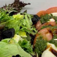 Caprese Salad · Field greens topped with tomatoes, mozzarella cheese, basil, balsamic glaze.
