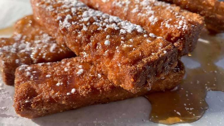 French Toast Sticks · French Toast sticks sprinkled with powdered sugar, served with maple syrup.