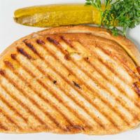 Milana Panini Sandwich · Roasted turkey, pork or turkey bacon, Swiss cheese, and honey mustard.
