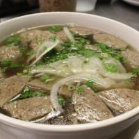 Beef Ball Soup · Beef ball soup topped with sliced onions and scallions.