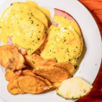 Classic Benedict · Two perfectly poached eggs, on applewood smoked ham and a toasted English muffin, topped wit...