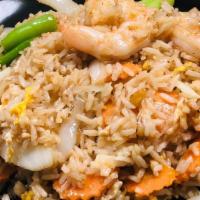 Thai Fried Rice · Fried rice with egg, onions, scallions and carrots in a brown sauce.