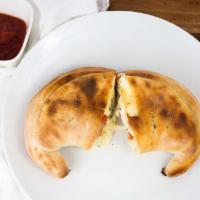 Calzone · Mozzarella and ricotta cheese with a side of marinara sauce.