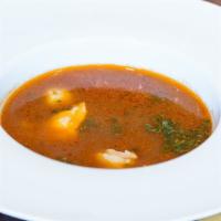 Seafood Soup · Based on tomato broth, fish stock, with pieces of salmon, shrimps, and scallops.