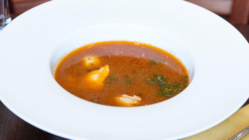 Seafood Soup · Based on tomato broth, fish stock, with pieces of salmon, shrimps, and scallops.