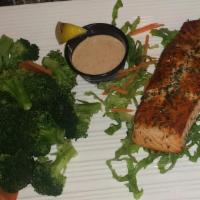 Grilled Salmon Steak · Our fresh salmon filet is flame-grilled with savory lemon and herb seasoning.