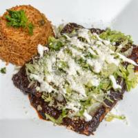 Enchiladas · Two enchiladas topped with cheese and sour cream served with a side of rice