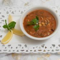 Moroccan Harira Soup  · Stew of chickpeas, tomatoes, Moroccan seasoning, lamb, & onions.