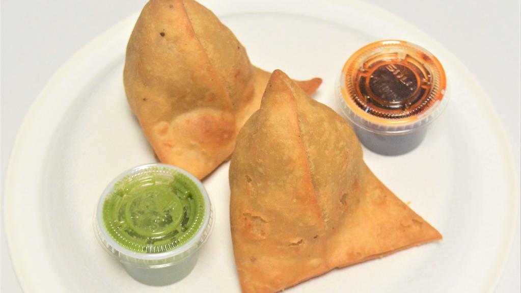 Vegetable Samosa (2) · Vegetarian. Peas and potatoes in a spicy red curry sauce are folded into white Flour wrappers and fried until golden brown in this classic appetizer. Potato, peas, vegetable oil, salt, chili powder, Turmeric Powder, Garlic, ginger, spices, coriander seeds, onions.