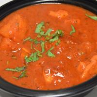 Lamb Vindaloo & Rice · Tangy hot sauce, tomato sauce, potato, onion, ginger, garlic and spices.
