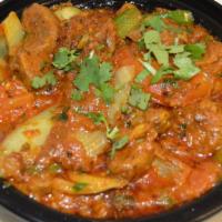 Lamb Karahi & Rice · Cubes of lamb cooked with green peppers, onions, tomatoes, gingers, garlic and herbs.