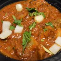 Lamb Do Pyaza & Rice · Lamb cubes in spicy curry garnished with onions.