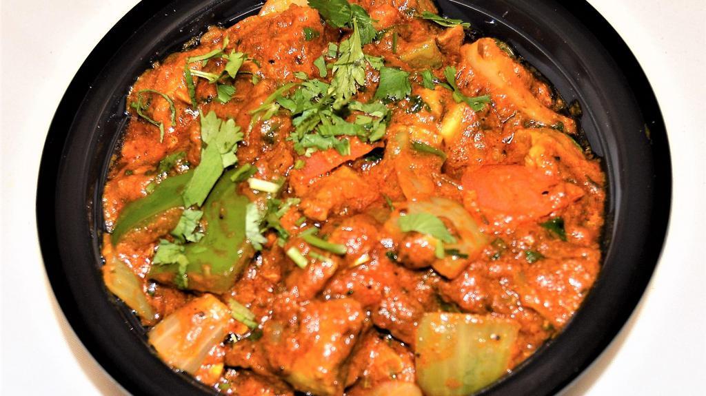 Goat Karahi & Rice · Spicy. Goat cooked with green peppers, onions, tomatoes, gingers, garlic and coriander.